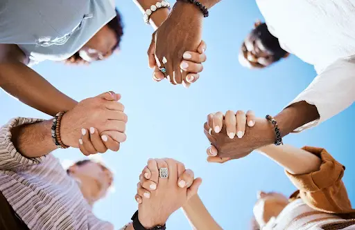 team holding hands | hoa board members